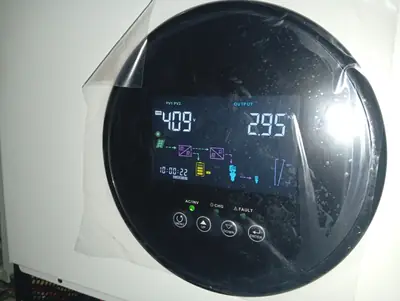 Inverter display mid-morning: solar coming in, house load going out