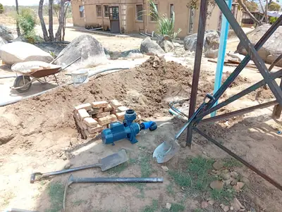 Pump on its brick plinth beside the tank stand